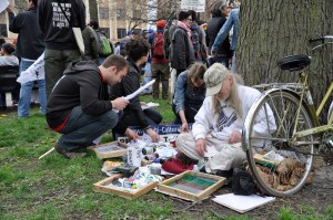 Chris Drew on location Silkscreening at May Day Rally ©nancy bechtol
